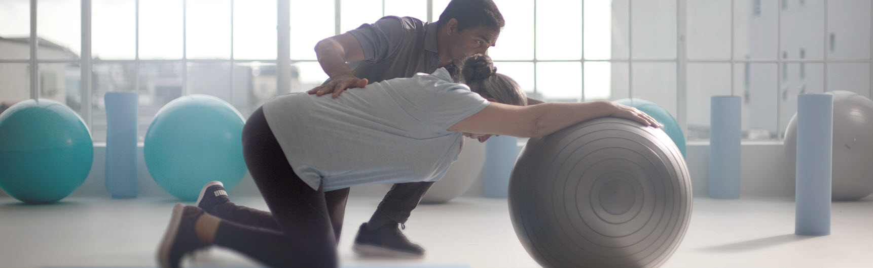 An instructor coaching a patient through physical rehabilitation