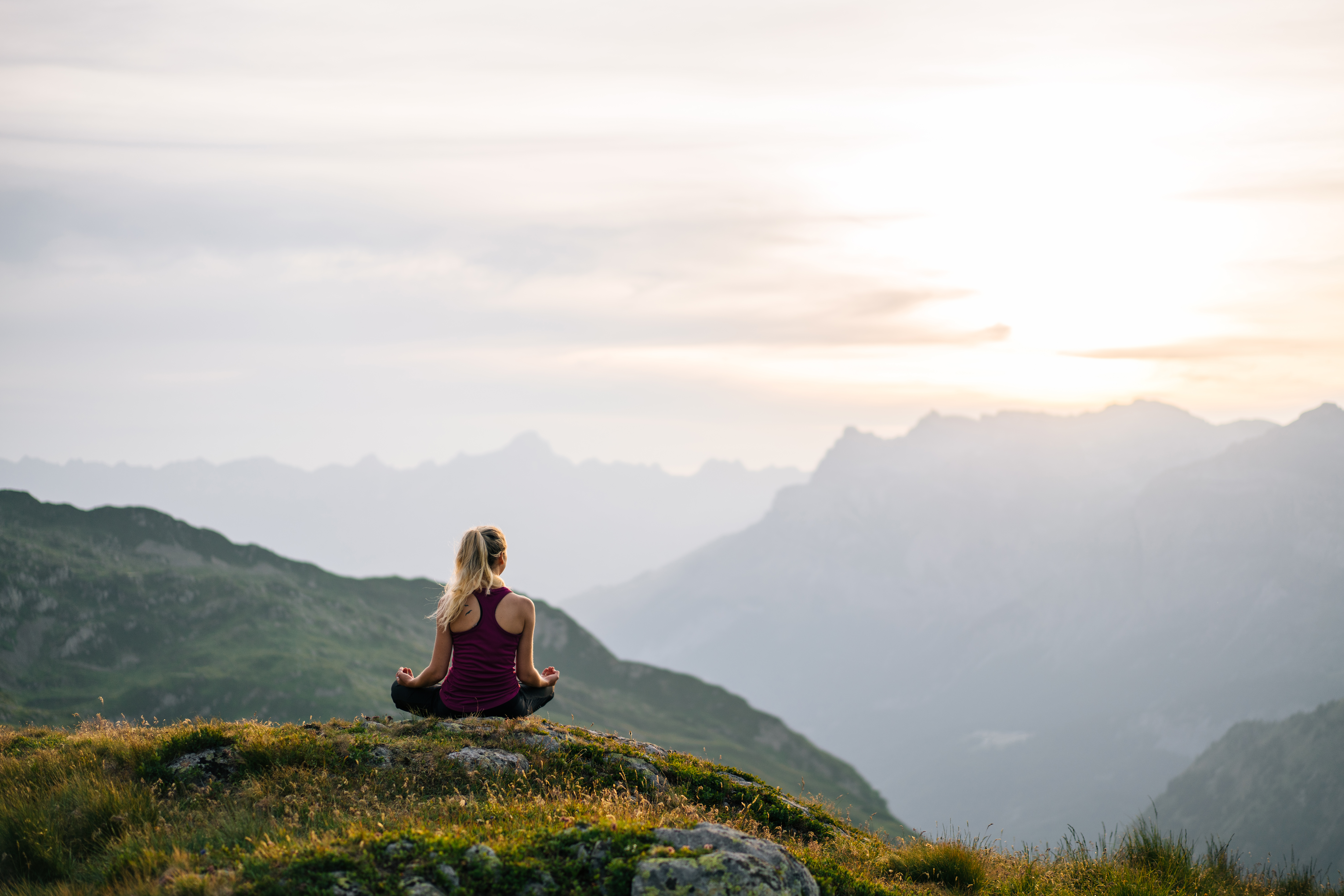 A woman meditating on a mountian