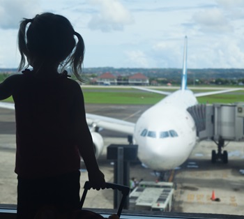 A girl looking out the window at the airport