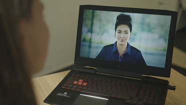 A woman looking at her laptop screen