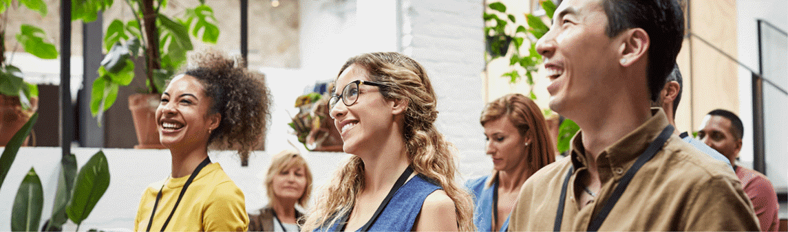 Colleagues laughing during an office meeting