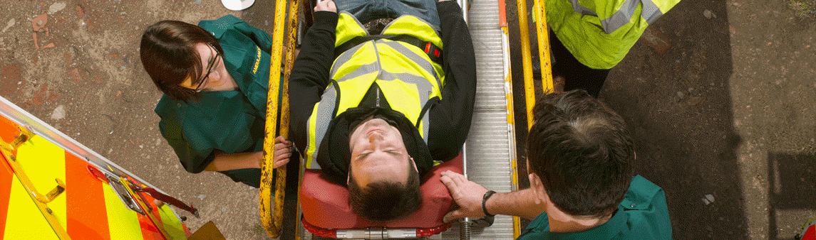 An injured man is placed into an ambulance on a stretcher