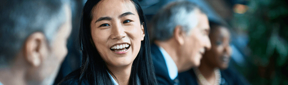 A woman smiling during a meeting 