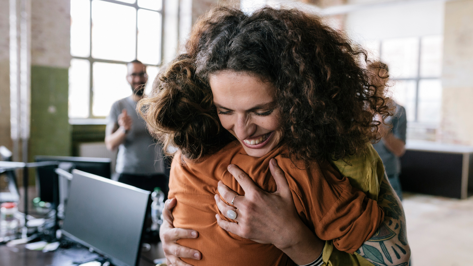 A woman hugs a child