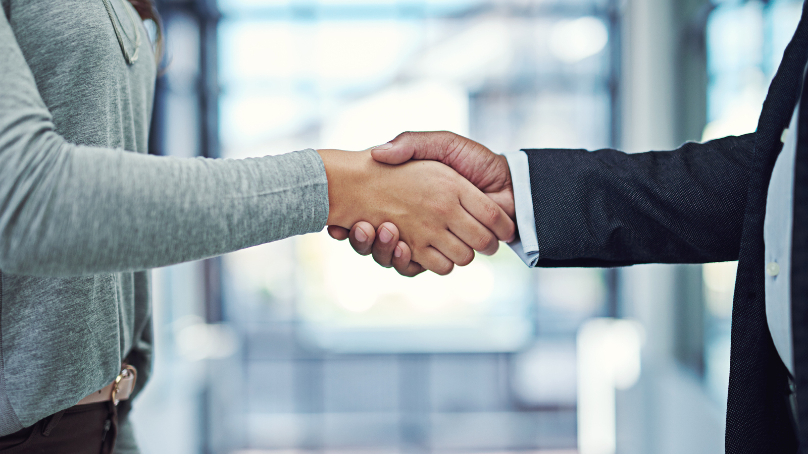 Southern Cross - Setting up employees for success Two people shake hands