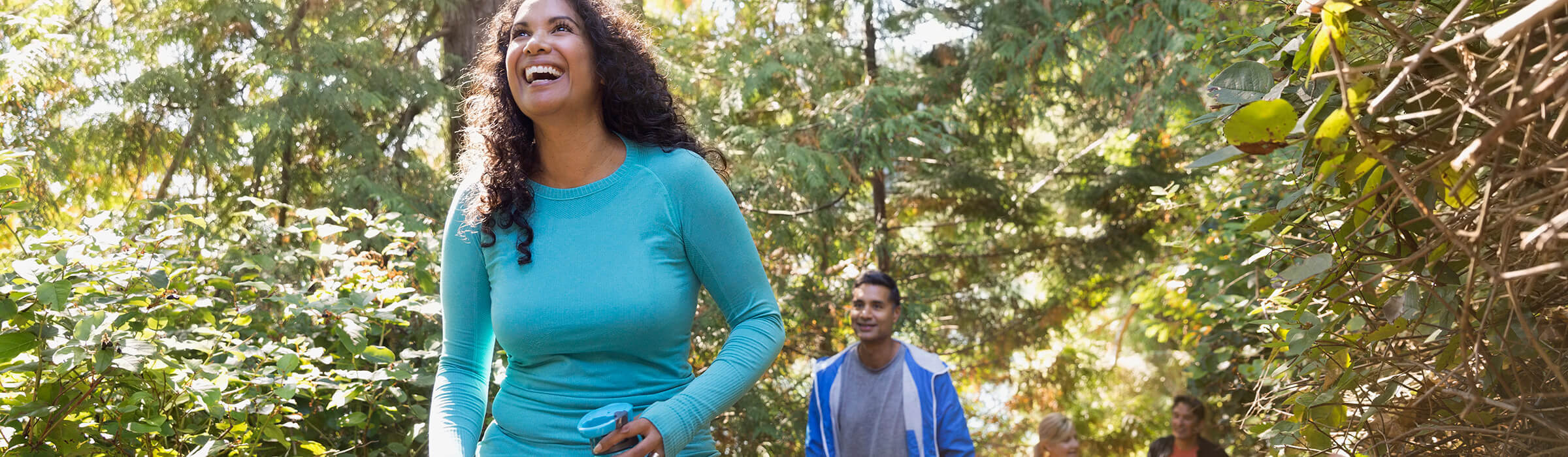 A man and woman are hiking in the woods