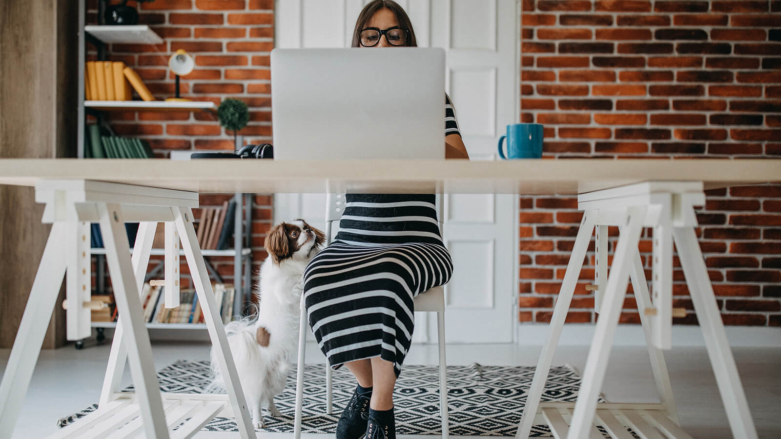 A woman works at a desk at home