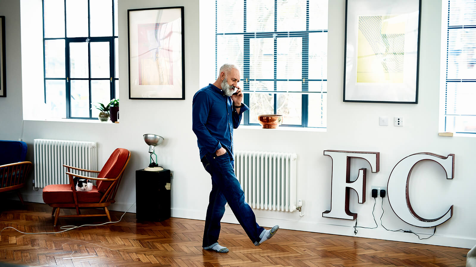 A man walks around while on the phone