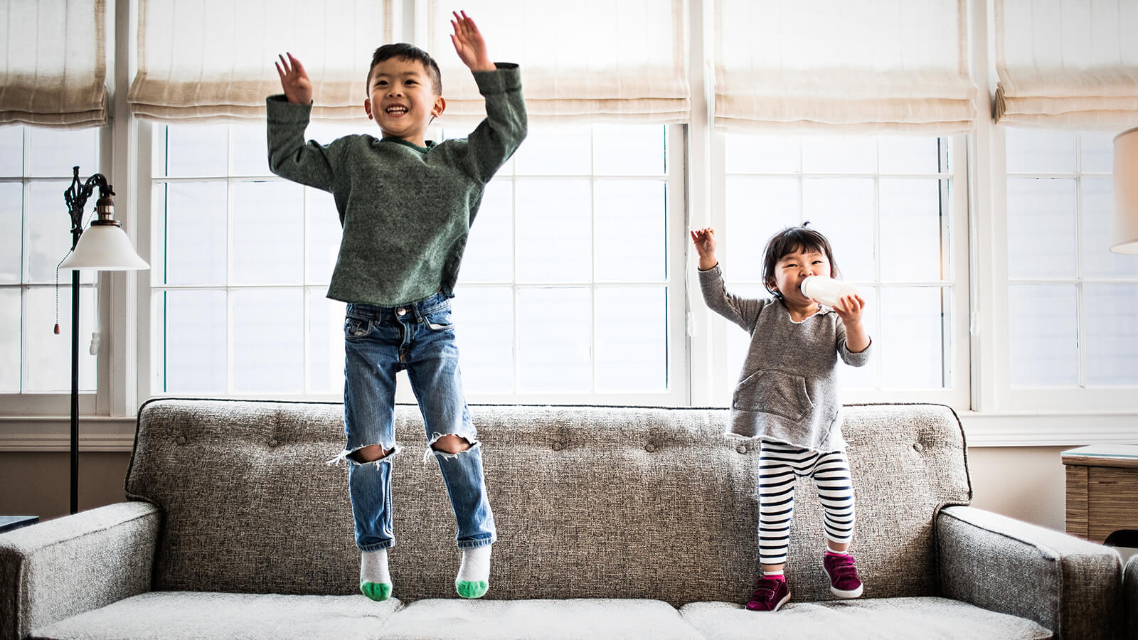 Southern Cross - Two young kids jump on the sofa Two young kids jump on the sofa