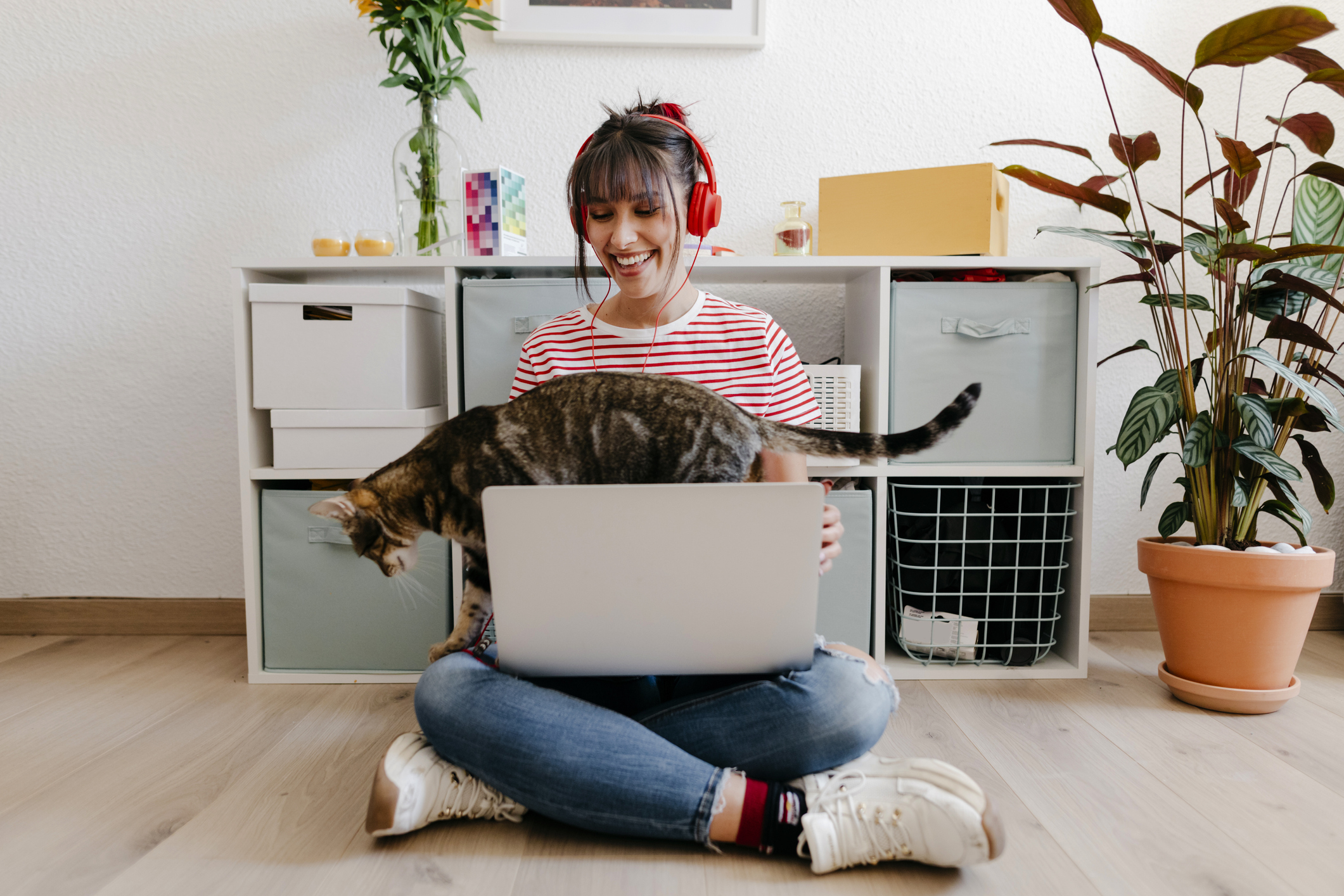 A woman works from home with her cat