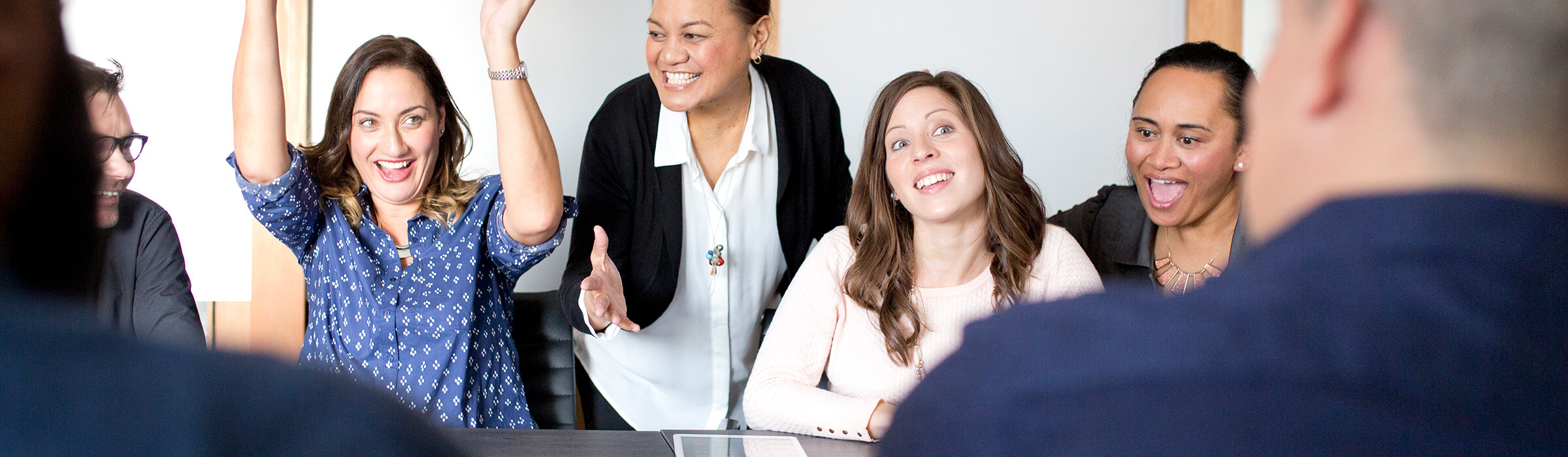 Colleagues cheer and celebrate in the office