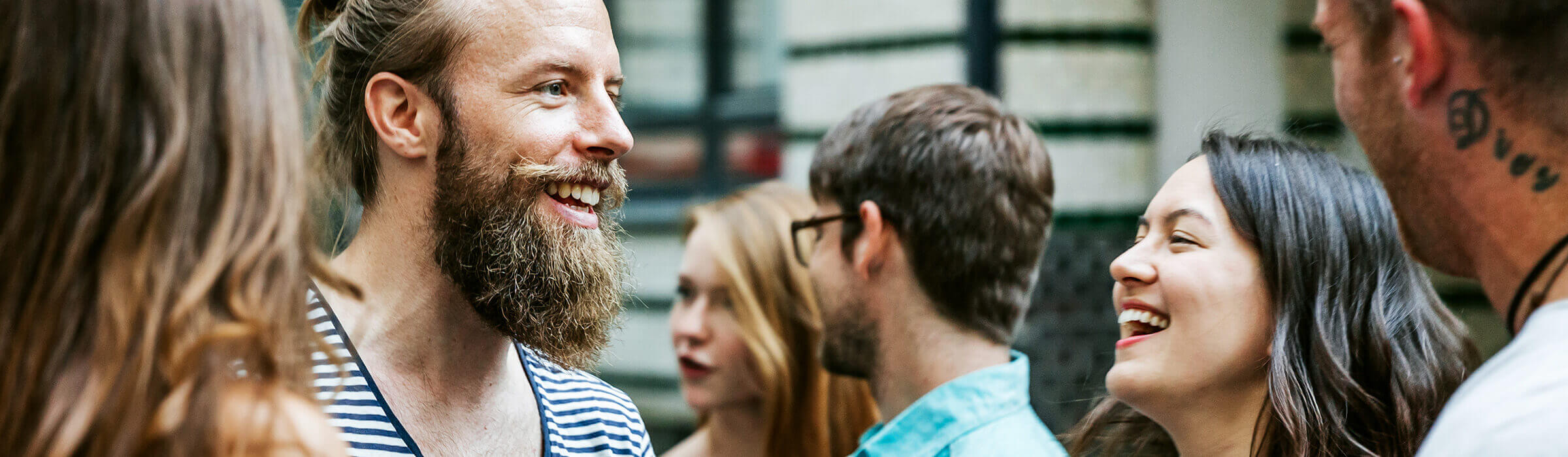 Some colleagues stand around and laugh together 