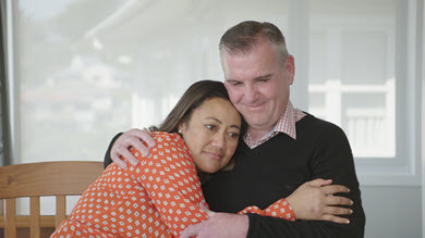 A husband and wife hugging