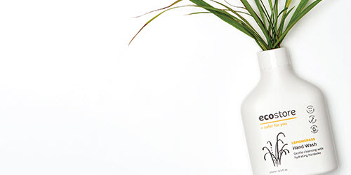 An ecostore bottle with a plant growing out of the top