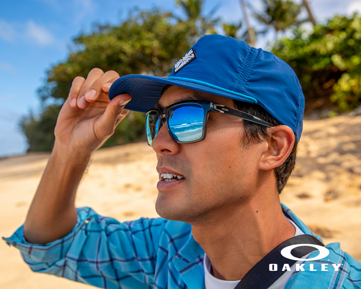 A man on a beach with Oakley glasses
