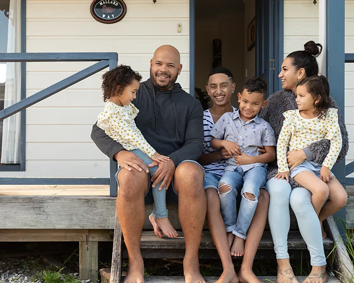 A family sitting together on their porch