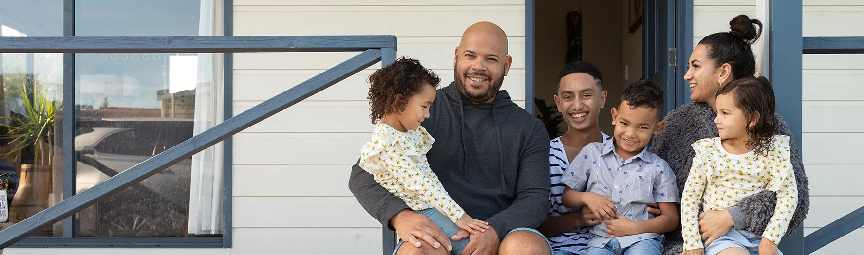 A family sitting together on their porch